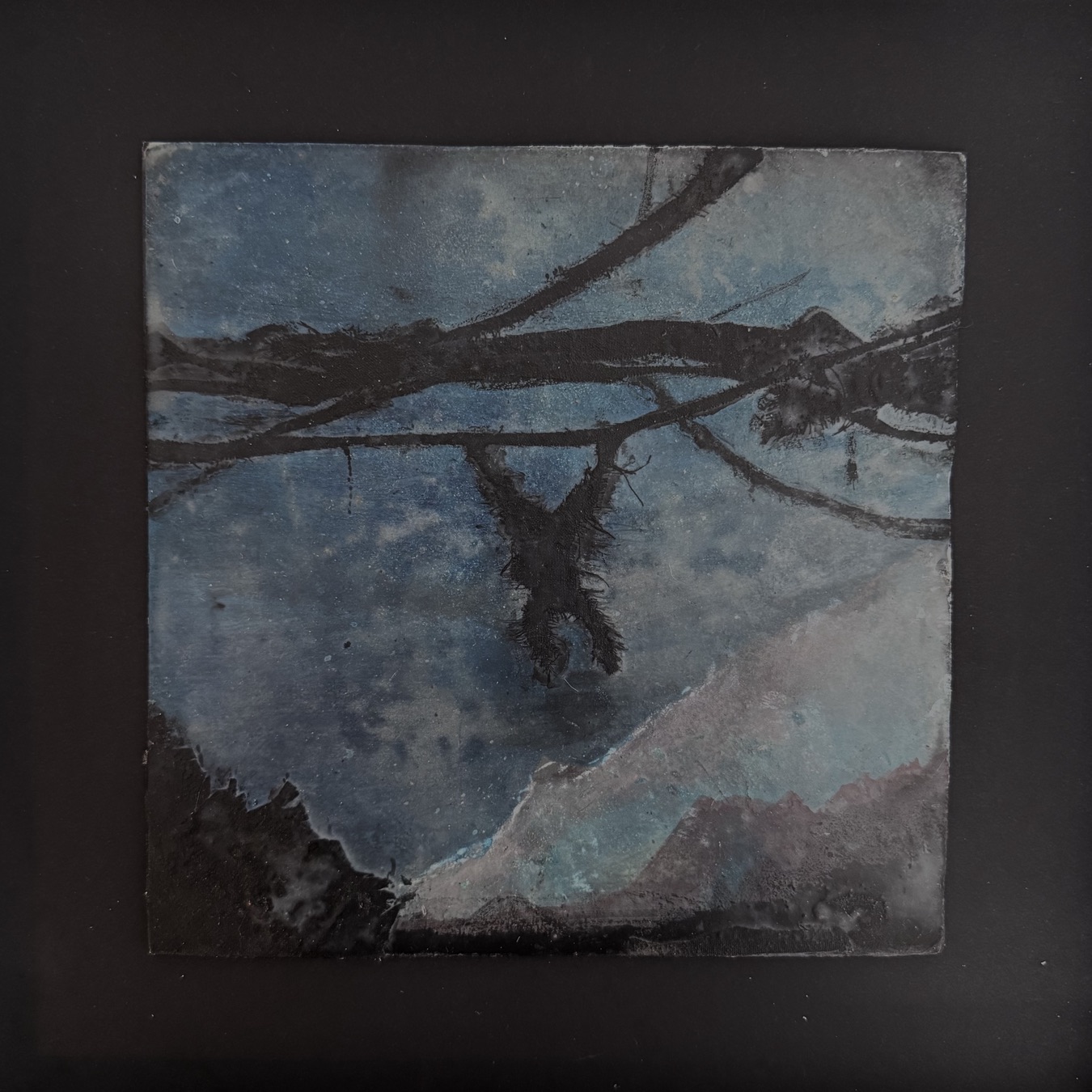 Dark, rough-textured figure hanging by the arms from a branch against a night sky. Original artwork “Wild Swing” by Andi Ipaktchi, used as header image for the text “Platonic Idiocy” by Caspar Schjelbred.